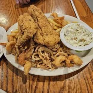 a plate of fried fish, fries, coleslaw and coleslaw