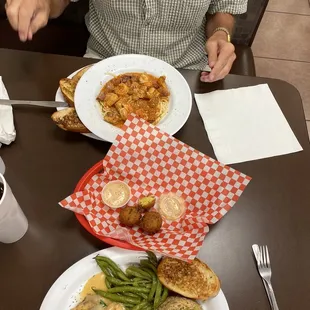 a man sitting at a table with plates of food