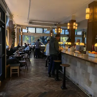 people sitting at tables in a restaurant