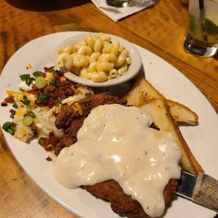 Chicken fried chicken served with toast, side of Mac n cheese, and a loaded potato