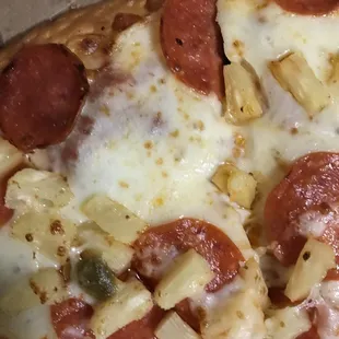 a pepperoni and pineapple pizza