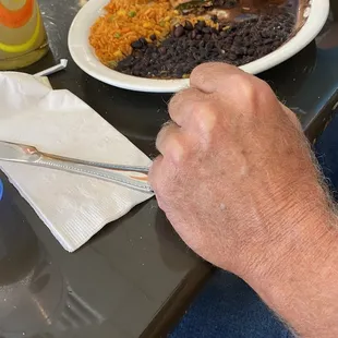 a person cutting a plate of food with a pair of scissors