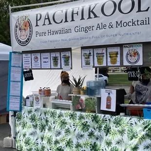 a booth with a table and a sign