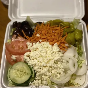 a salad in a styrofoam container