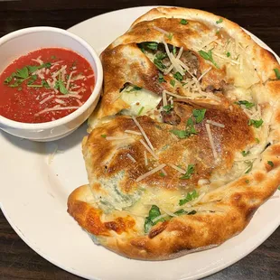 Large(!) calzone - sausage, mush and spinach.  Excellent marinara on the side.