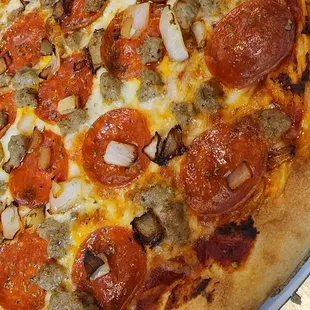 a pizza with pepperoni and onions