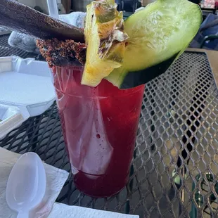 The Jamaica-Strawberry Agua Fresca. Refreshing and delicious, with a Tajin rim, cucumber and pineapple slices, and tamarind straw.