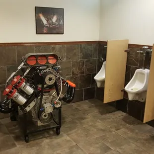 a motorcycle engine in a men's restroom