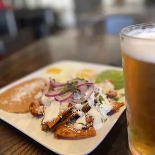 a glass of beer and a plate of food