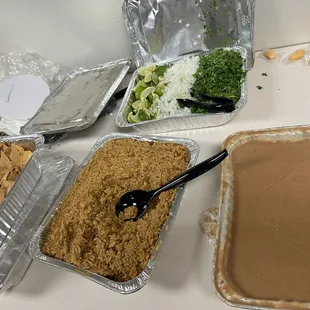 Arroz, frijoles, home made chips and all the toppings for tacos