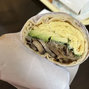 a wrap with mushrooms and avocado