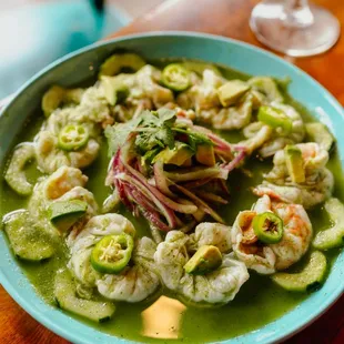 Aguachiles verdes- butterfly shrimp marinated in lime and pepper, served with onion, cucumber, and cilantro. Spicy and refreshing.