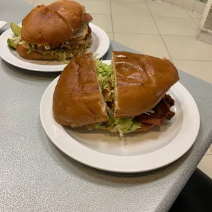 two plates of sandwiches on a table