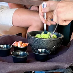 a man eating a bowl of guacamole