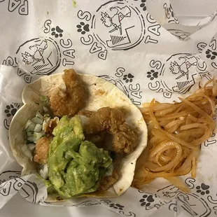 Fried Shrimp taco w/ guacamole and grill onions.