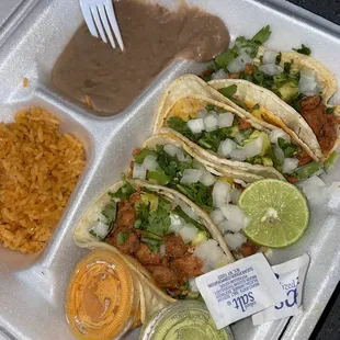 a tray of tacos and rice