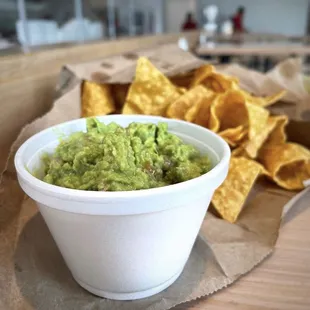 a bowl of guacamole and chips