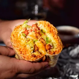 a person holding a burrito