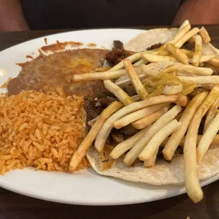 Tacos Campechanos: steak and chorizo taco topped with onions and fries. Flavor explosion and very filling.