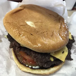 a hamburger with cheese and tomato