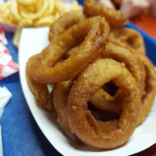 a plate of onion rings and fries