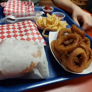 a blue tray with onion rings, onion rings, and ketchup