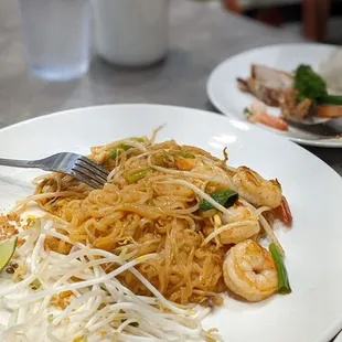 a plate of noodles and shrimp