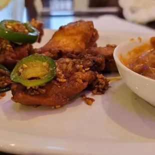 Garlic wings with peanut sauce.