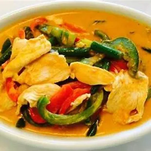 a bowl of curry with chicken and vegetables