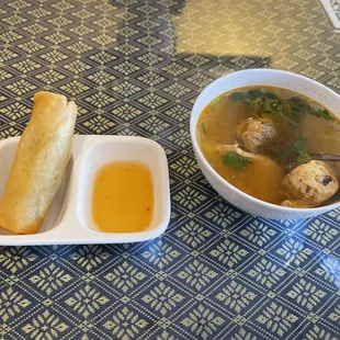 a bowl of soup and a piece of bread