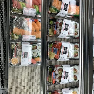 a variety of sushi in a display case