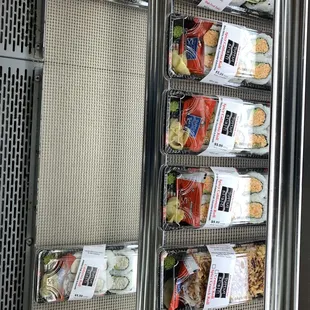 several trays of food on display