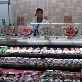 a man behind a sushi counter