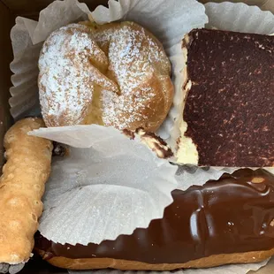 Clockwise from top left: cream puff, tiramisu, cannoli and chocolate eclair