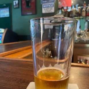 a glass of beer on a napkin