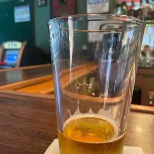 a glass of beer on a napkin