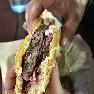 a person holding a sandwich