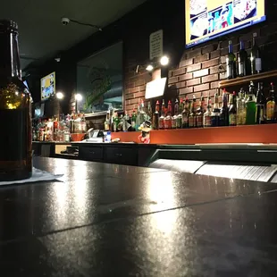 a beer bottle on a bar counter