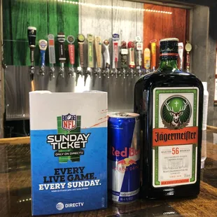 a bottle of beer and a can of red bull