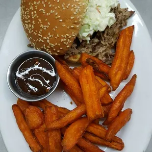 In-house Smoked Pulled Pork topped with Cole Slaw and Sweet Potato Fries.  Homemade BBQ Sauce