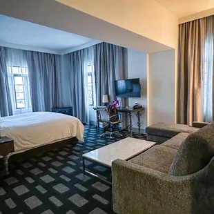 Head Honcho Suite corner room with sofa, tv, and wet bar