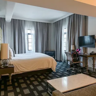 Head Honcho Suite corner room with sofa, tv, and wet bar