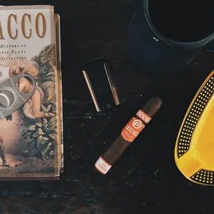 a cigar and a book on a table