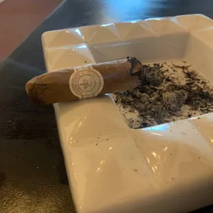 Lit Montecristo Cigar on an ash tray at Padres Cigars
