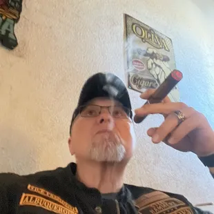 Sitting in the lounge enjoying a cigar.