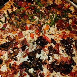 a pizza with various toppings on a pan