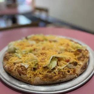 a pizza with cheese and lettuce