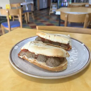 two sausage sandwiches on a plate