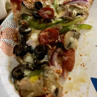 A slice from the large Supreme Pizza