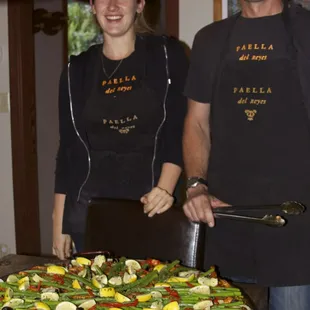 Tom and daughter 5/24/14 getting ready to serve 35-40 of us 1sts and then 2nds and then some left over! Yummy